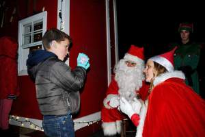 Image of Whilden communicating in ASL with a child at Santa's Mailbox.